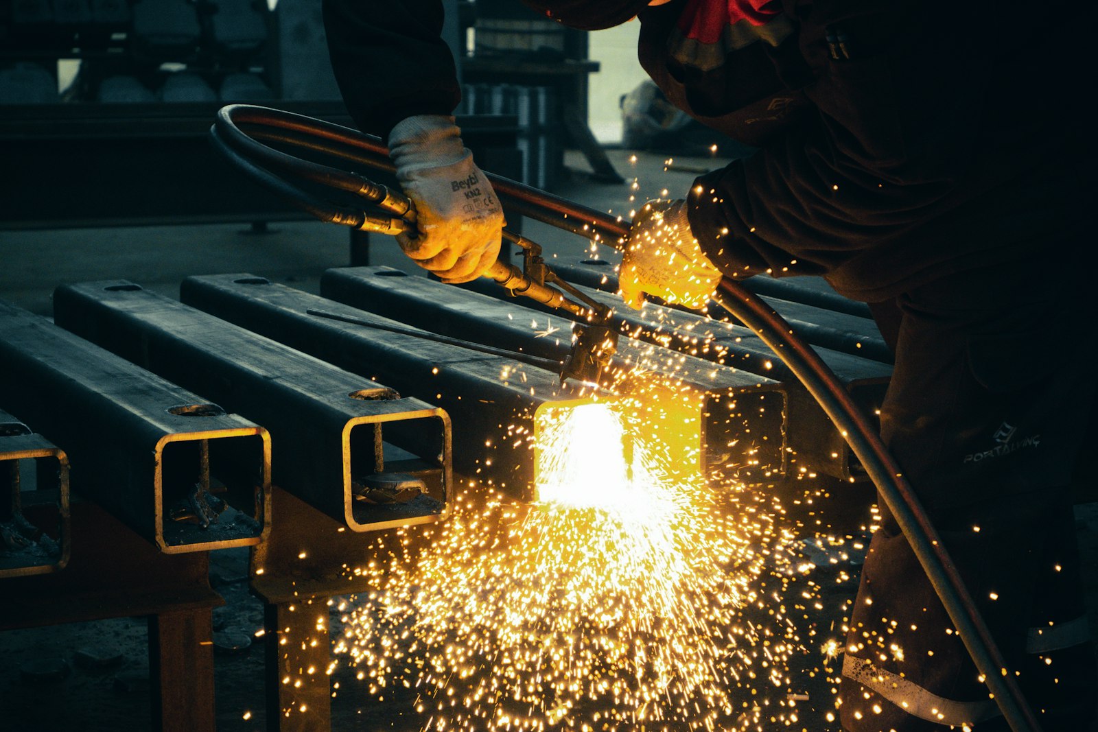 Sparks flying as steel sections are cut and welded